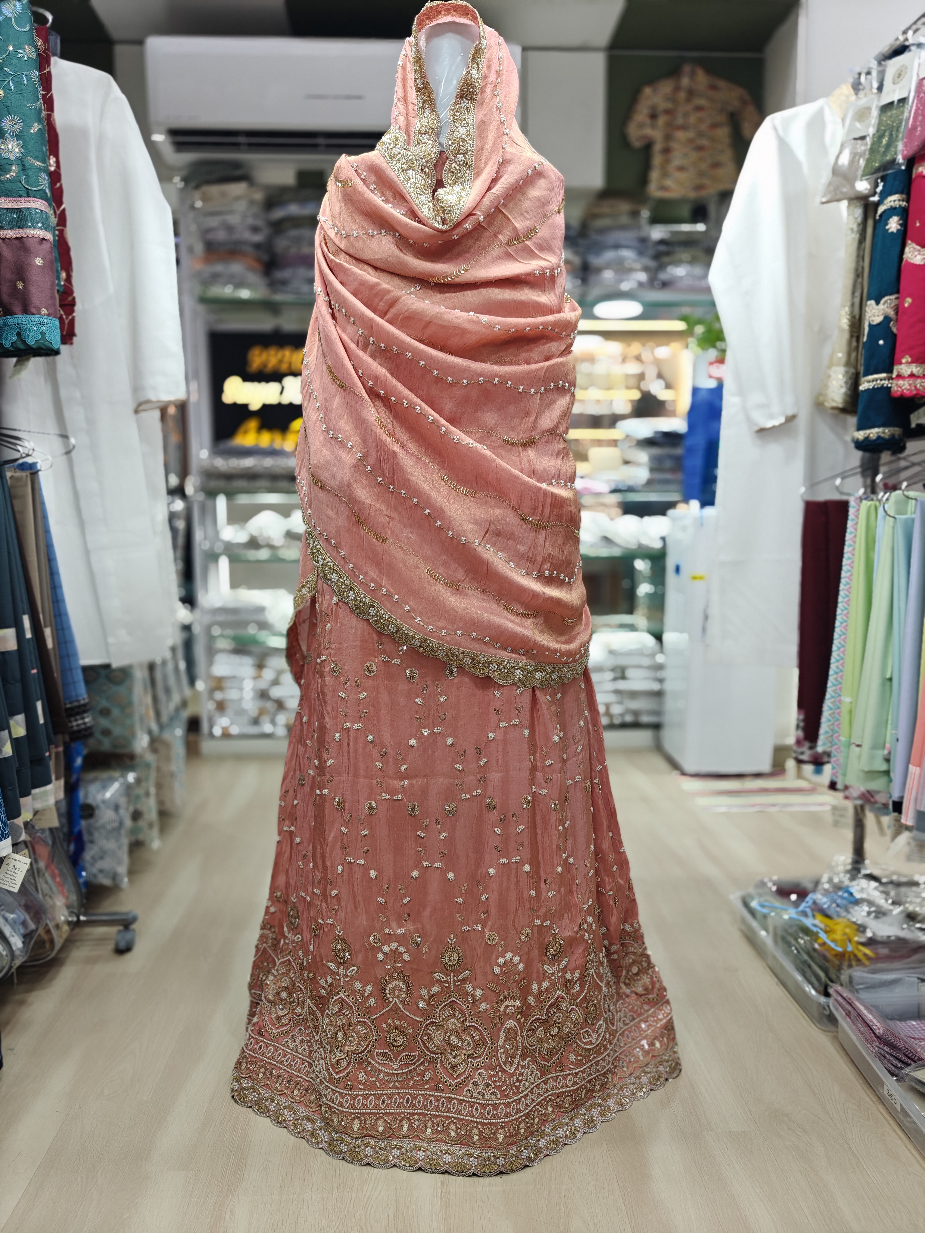  11000 Peach Dulhan Jori with antique gold n champagne gold embroidery, Ghagra has butti motifs, with traditional floral paisley embroidered scalloped border, dupattas has fine embellishments, subtle shimmer n gold embroidered scalloped border